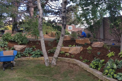 This is an example of a large rustic drought-tolerant and partial sun backyard brick landscaping in Denver for summer.
