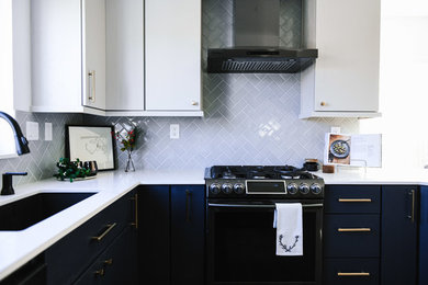 Eat-in kitchen - mid-sized modern u-shaped vinyl floor and gray floor eat-in kitchen idea in San Diego with an undermount sink, flat-panel cabinets, blue cabinets, quartz countertops, gray backsplash, ceramic backsplash, black appliances, a peninsula and white countertops