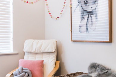 Photo of a mid-sized scandinavian toddler room in Melbourne with white walls, carpet and grey floor.