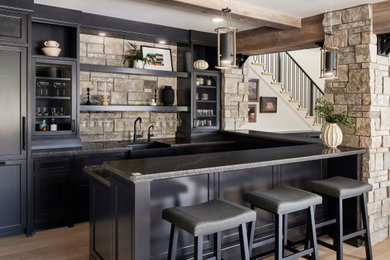 Home bar - traditional home bar idea in Minneapolis with quartz countertops and black countertops