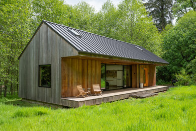 Inspiration for a small rustic one-story wood exterior home remodel in Portland with a metal roof and a gray roof