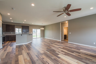 This is an example of a large arts and crafts open concept living room in Seattle with laminate floors and multi-coloured floor.