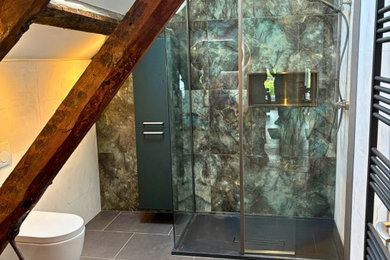 Medium sized contemporary family bathroom in West Midlands with flat-panel cabinets, green cabinets, a walk-in shower, a one-piece toilet, green tiles, porcelain tiles, porcelain flooring, a vessel sink, laminate worktops, grey floors, an open shower, grey worktops, a wall niche, double sinks, a floating vanity unit and exposed beams.