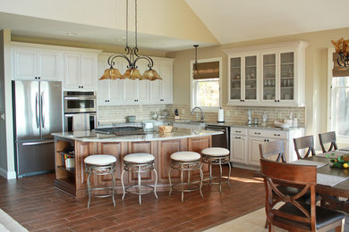 Mid-sized arts and crafts l-shaped dark wood floor and brown floor eat-in kitchen photo in Other with white cabinets, granite countertops, multicolored backsplash, stainless steel appliances, an island and raised-panel cabinets