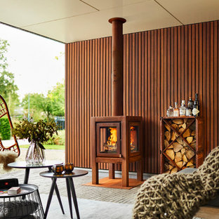 Photo of a large scandinavian patio in Amsterdam with with fireplace and a pergola.