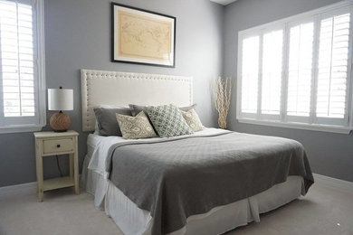 Example of a transitional bedroom design in Tampa