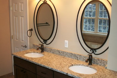 Mid-sized traditional master bathroom in Baltimore with shaker cabinets, dark wood cabinets, beige walls, porcelain floors, an undermount sink and brown floor.