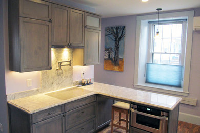 Mid-sized transitional cork floor and brown floor kitchen photo in Boston with shaker cabinets, gray cabinets, stainless steel appliances, a peninsula and gray countertops