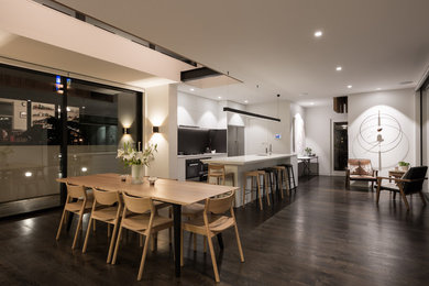Photo of a modern kitchen in Auckland with light hardwood floors and brown floor.