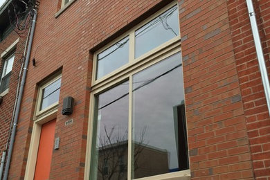 Example of a small classic red two-story brick exterior home design in Philadelphia