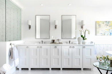 Design ideas for a mid-sized contemporary master bathroom in Los Angeles with shaker cabinets, white cabinets, a freestanding tub, a corner shower, a two-piece toilet, white tile, mosaic tile, white walls, marble floors, an undermount sink and solid surface benchtops.