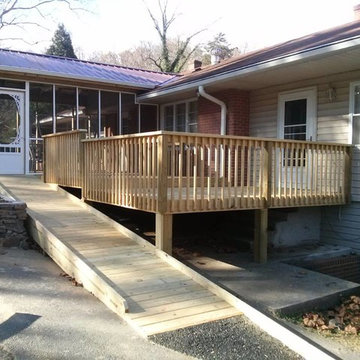 screened in porch with metal roof, deck and handicap ramp