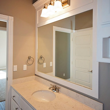 Guest Bathroom with White Cabinets and Mirror Trim