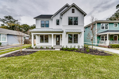 Example of a mid-sized farmhouse white two-story concrete fiberboard exterior home design in Jacksonville with a shingle roof