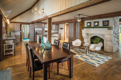 Example of a large mountain style medium tone wood floor and brown floor great room design in Louisville with a standard fireplace