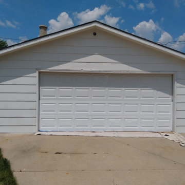 Front of Garage featuring Contrasted Finished/Unfinished Door