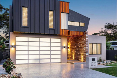 Inspiration for a mid-sized contemporary attached three-car garage in Central Coast.