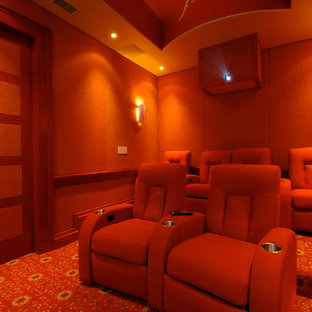 Inspiration for a medium sized bohemian enclosed home cinema in Charleston with a projector screen, orange walls, carpet and orange floors.