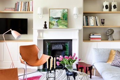 Photo of a living room in Sydney with grey walls, light hardwood floors, a standard fireplace and a wall-mounted tv.