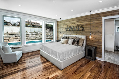 Large mountain style master dark wood floor and brown floor bedroom photo in Austin with brown walls and no fireplace