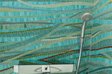 Inspiration for a beach style bathroom in Paris with mosaic tile, blue walls, mosaic tile floors and glass benchtops.