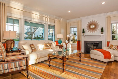 Inspiration for a mid-sized coastal formal and enclosed medium tone wood floor and brown floor living room remodel in Boston with beige walls, a standard fireplace and no tv