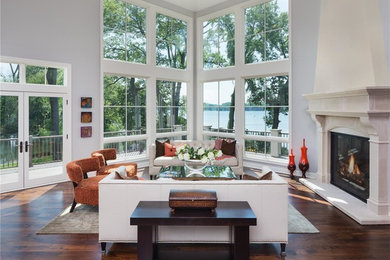 Inspiration for a large timeless formal and open concept medium tone wood floor living room remodel in Orange County with gray walls, a standard fireplace, a stone fireplace and no tv