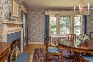 Kitchen/dining room combo - huge traditional light wood floor kitchen/dining room combo idea in New York with blue walls, a standard fireplace and a wood fireplace surround