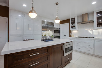 Inspiration for a large contemporary l-shaped ceramic tile eat-in kitchen remodel in Los Angeles with an island, a farmhouse sink, recessed-panel cabinets, white cabinets, quartzite countertops, white backsplash, stainless steel appliances and porcelain backsplash