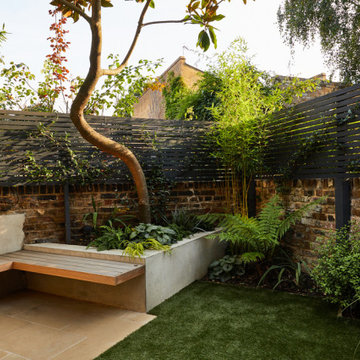 London, Islington. Tiny garden with outdoor fireplace and built-in barbecue area