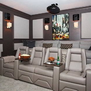 Large classic enclosed home cinema in Jacksonville with carpet and a projector screen.