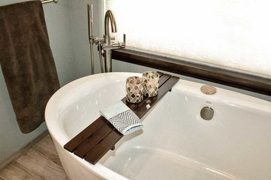 Inspiration for a mid-sized transitional master multicolored tile and glass tile bathroom remodel in Portland with raised-panel cabinets, medium tone wood cabinets, green walls, a drop-in sink, quartz countertops and a hinged shower door