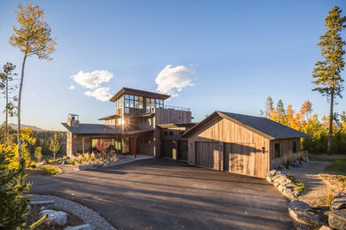 Example of a large mountain style brown two-story wood house exterior design in Denver with a hip roof and a shingle roof