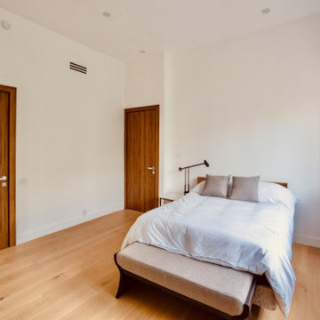 Bedroom With Window Bench and Walnut Door