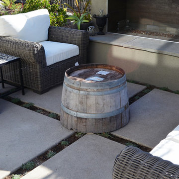 Linear fireplace, wine barrel accents, outdoor wicker chairs