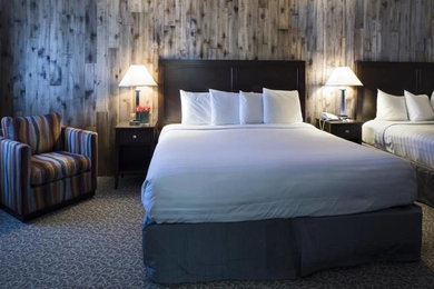 Mid-sized trendy master medium tone wood floor and gray floor bedroom photo in San Francisco with gray walls