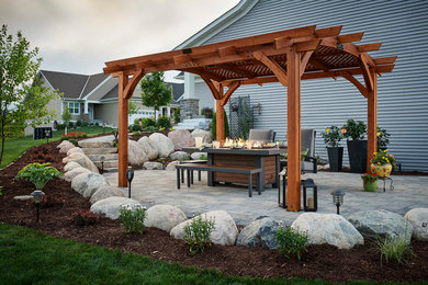Inspiration for a modern patio in Minneapolis with a fire feature and a pergola.