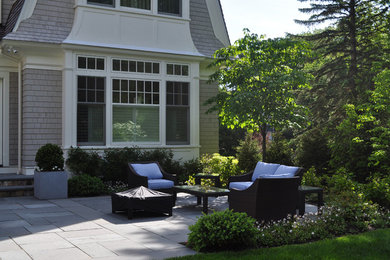 Inspiration for a large traditional backyard patio in Boston with concrete pavers and no cover.
