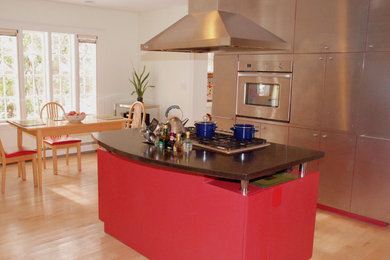 Eat-in kitchen - mid-sized contemporary l-shaped light wood floor eat-in kitchen idea in Boston with stainless steel cabinets, white backsplash, stainless steel appliances and an island