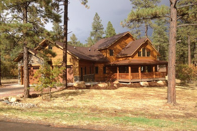 Example of a large mountain style beige two-story mixed siding exterior home design in Albuquerque with a metal roof