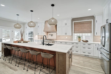 Kitchen - large transitional laminate floor and multicolored floor kitchen idea in Other with recessed-panel cabinets, quartz countertops, beige backsplash, stainless steel appliances, an island and white countertops