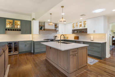 Mid-sized trendy l-shaped light wood floor and brown floor kitchen pantry photo in Other with a single-bowl sink, flat-panel cabinets, green cabinets, quartz countertops, white backsplash, ceramic backsplash, stainless steel appliances, an island and white countertops