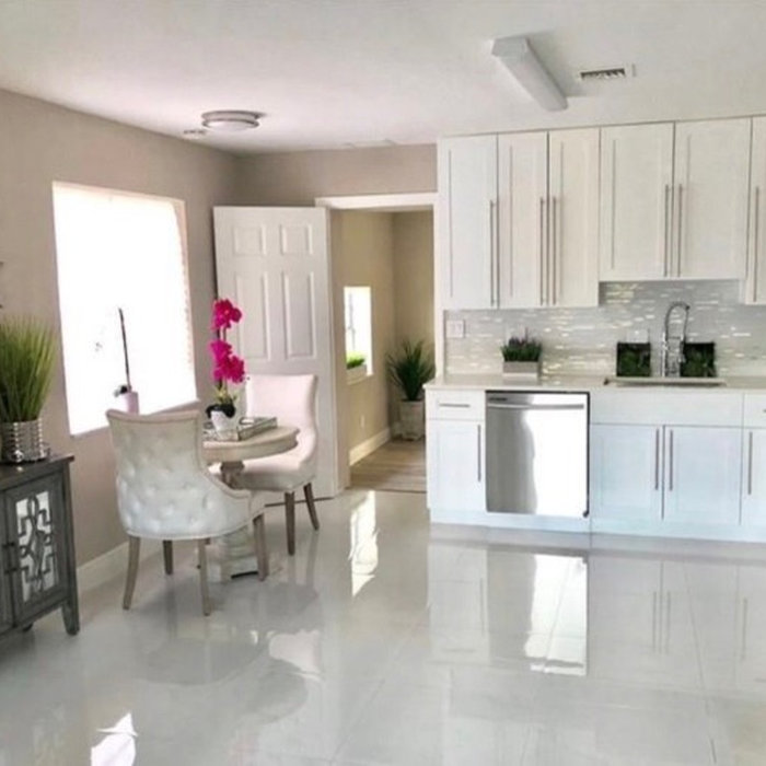 Open concept kitchen - small modern l-shaped porcelain tile and white floor open concept kitchen idea in Miami with an undermount sink, shaker cabinets, white cabinets, stainless steel appliances, no
