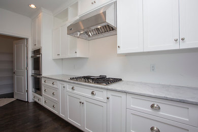 Kitchen - large contemporary l-shaped dark wood floor and brown floor kitchen idea in Chicago with shaker cabinets, white cabinets, marble countertops and stainless steel appliances