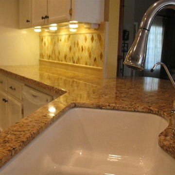 Juparana Granite counter-top with a rhomboid onyx back-splash