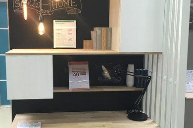 Small contemporary study room in Montpellier with black walls, laminate floors, no fireplace and a built-in desk.