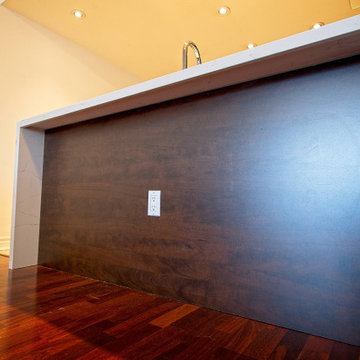 Dark Finished Peninsula Back Beneath a Quartz Seating Overhang | Downtown Toront