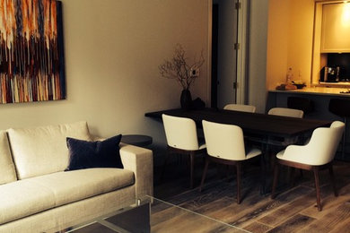 Example of a trendy open concept medium tone wood floor and brown floor living room design in Miami with white walls, a wall-mounted tv and no fireplace