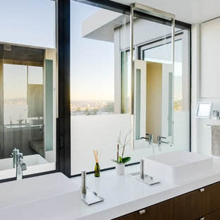 Example of a minimalist beige floor bathroom design in San Francisco with flat-panel cabinets, dark wood cabinets, white walls, a vessel sink and white countertops