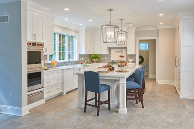 Mid-sized transitional l-shaped vinyl floor and beige floor enclosed kitchen photo in Newark with a farmhouse sink, shaker cabinets, white cabinets, marble countertops, gray backsplash, ceramic backsplash, stainless steel appliances and an island